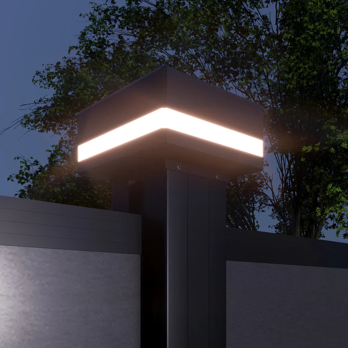 Solar LED fence post cap light illuminated at night on modern aluminum fence