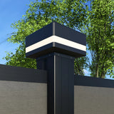 Solar LED fence post cap light installed on black aluminum fence post in daylight