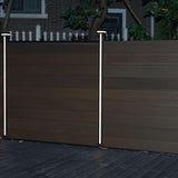 Vertical LED fence post lights installed on WPC composite privacy fence at night