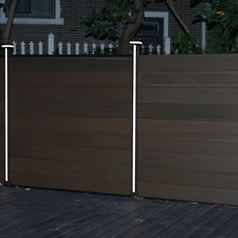 Vertical LED fence post lights installed on WPC composite privacy fence at night