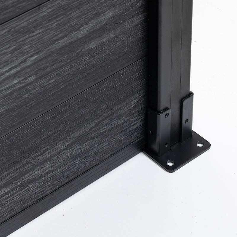 Close-up of black aluminum fence post base with co-extruded composite fence panel showing durable mounting and modern wood-grain finish