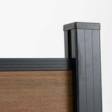 Black aluminum fence post cap with wood grain composite fence panel, co-extruded composite outdoor fencing detail