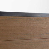 Wood grain composite fence board close up with black top rail, co-extruded composite outdoor fencing detail