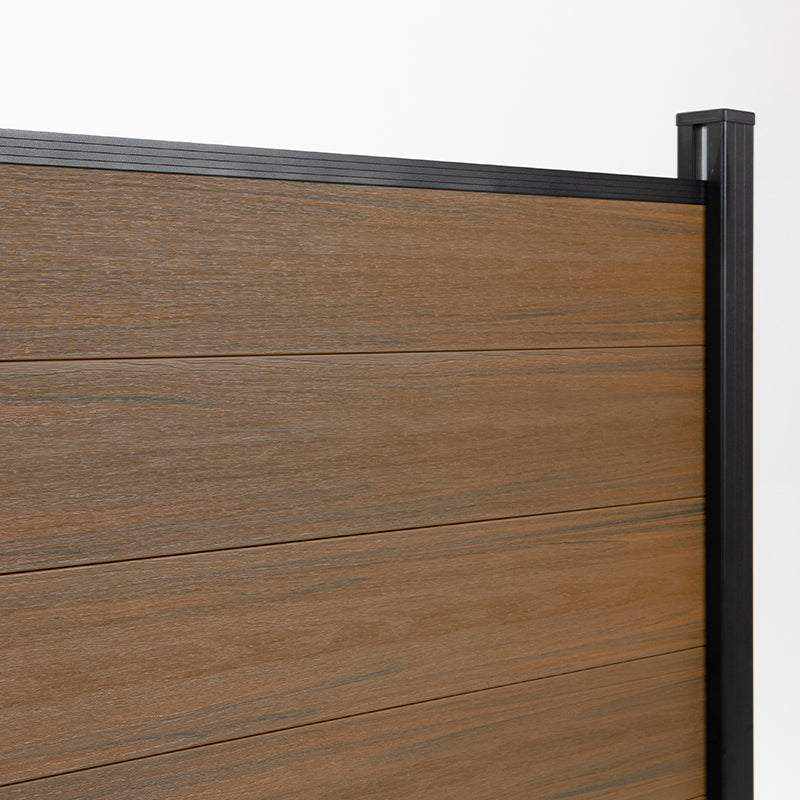 Wood grain composite fence panel close up with black aluminum post, co-extruded composite outdoor fencing detail
