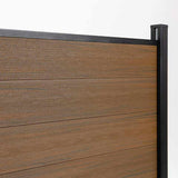 Wood grain composite fence panel close up with black aluminum post, co-extruded composite outdoor fencing detail