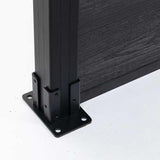 Close-up of black aluminum fence post base with dark composite fence panel installed