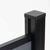 Black aluminum fence post cap and top rail connection with gray composite fence panel, modern outdoor fencing detail