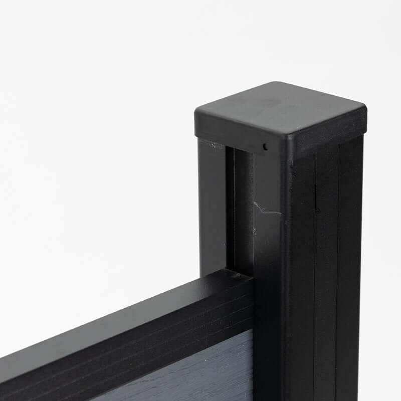 Black aluminum fence post cap and top rail connection with gray composite fence panel, modern outdoor fencing detail