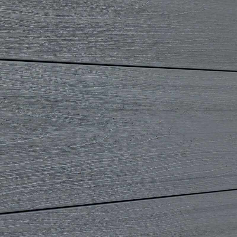 Gray composite fence boards with realistic wood grain texture, close up of outdoor composite fencing panels