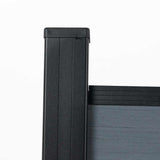 Black aluminum fence post detail with composite fence panel, modern outdoor privacy fencing component