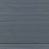 Gray composite fence boards with natural wood grain finish, close up view of outdoor composite fencing panels