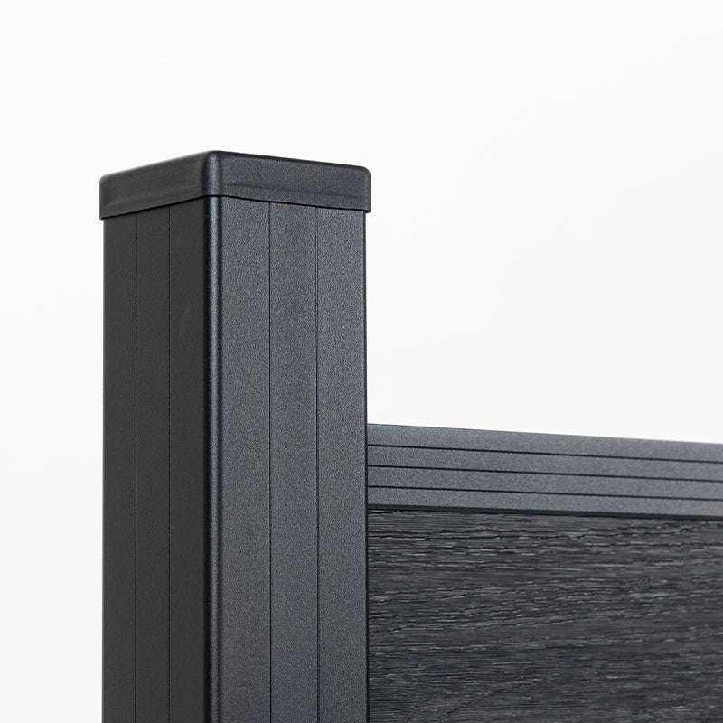 Black aluminum fence post with cap attached to composite fence panel top rail