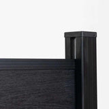 Close-up of composite fence panel top rail with black aluminum post and cap