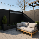 Black composite privacy fence with ventilation panel in modern outdoor seating area